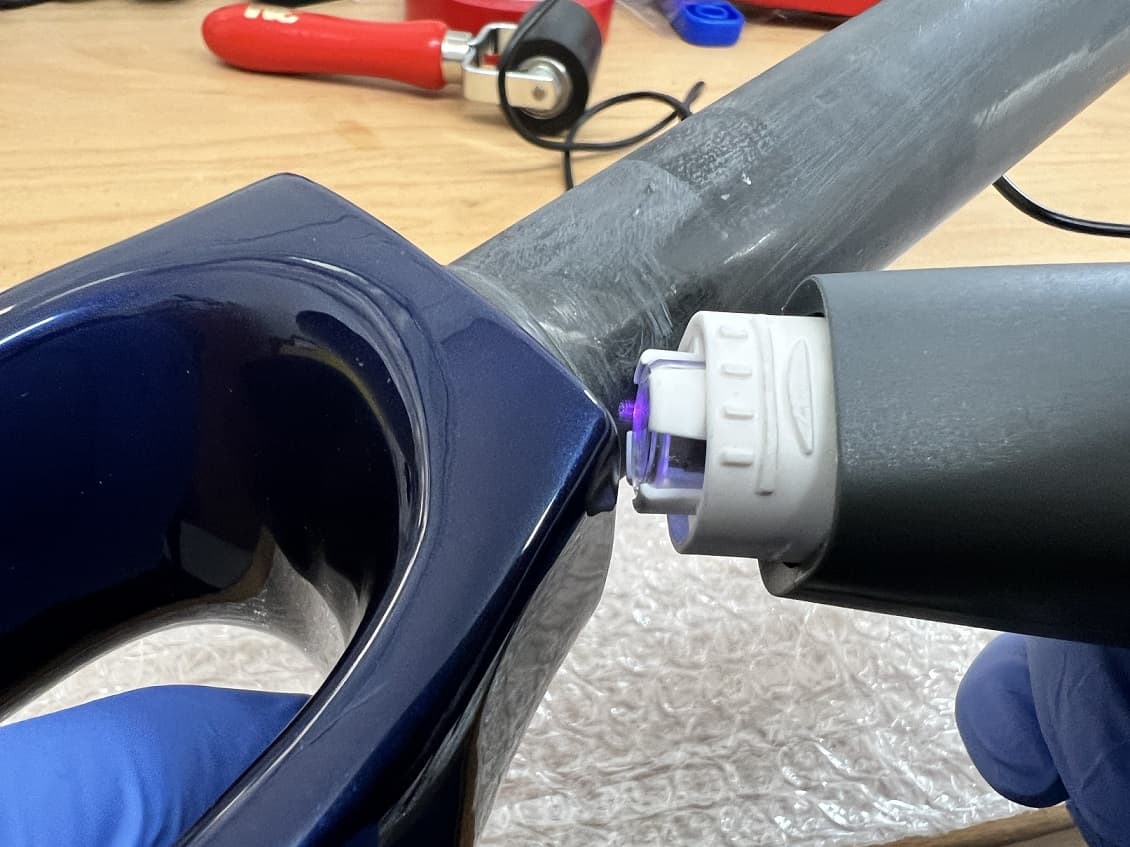 Plasma treatment on a carbon bicycle fork to increase the adhesion for a 2K adhesive used to insert the ball bearing shell